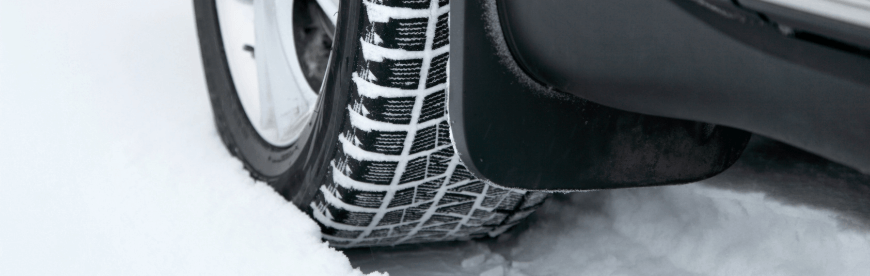Why Winter Tires Are a Necessity in Cleveland Heights OH with Swedish Solutions; close up image of snow tires on car driving in snow