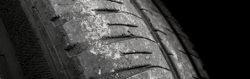 Tire Wear Patterns: What's Wrong with My Vehicle? | Swedish Solutions in Cleveland Heights OH. Closeup image of a worn-out tire.
