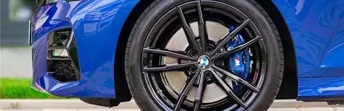 Is it Time for BMW Brake Service? | Heights Swedish Solutions in Cleveland Heights, OH. Closeup image of side-front view of blue BMW.