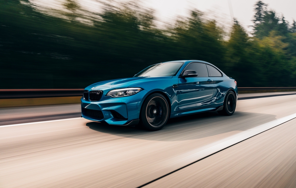 BMW Maintenance Tips from Heights Swedish Solutions | Cleveland Heights European Auto Repair. Image of blue BMW driving on washington state road.