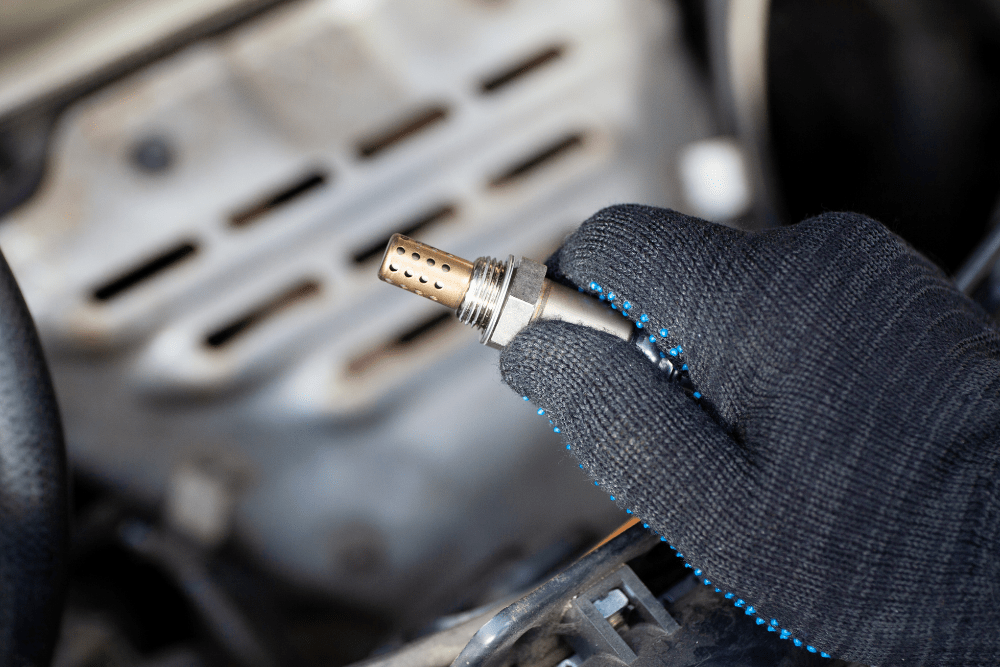 oxygen sensor repair, foreign auto repair in Cleveland Heights, OH at Heights Swedish Solutions. An image showing a gloved hand holding an oxygen sensor (O2 sensor).